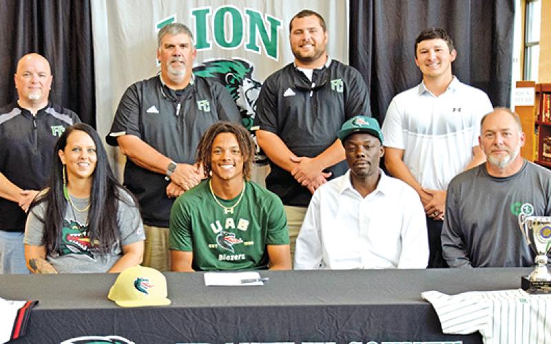 C.J. Blackwell signed a college baseball scholarship recently. A celebration was held for him at Franklin County High School. Pictured are (front, from left) his mother Laura Smith, C.J., his father Corey Blackwell, Franklin County Athletic Director Jason Oliver, (back) Franklin County High School Principal Roger Wilkinson, FCHS Baseball Coach David Skelly and assistant coaches Ryan Phillips and Elliott Beard. (Photo by Scoggins)