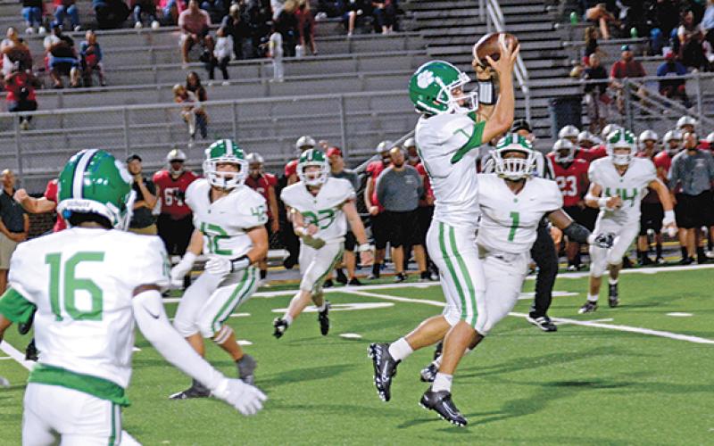 Lion Dee Oliver jumps up to snag an interception in the third quarter of Friday's game at Jackson County. Oliver returned the interception for his second touchdown of the game. His first came on the second-half kickoff return. (Photo by Scoggins)