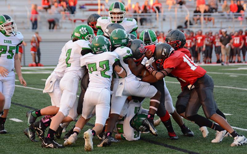 The Franklin County Middle School Cub defense stacks up a Madison ballcarrier during the region championship game Thursday in Danielsville. (Photos by Scoggins)