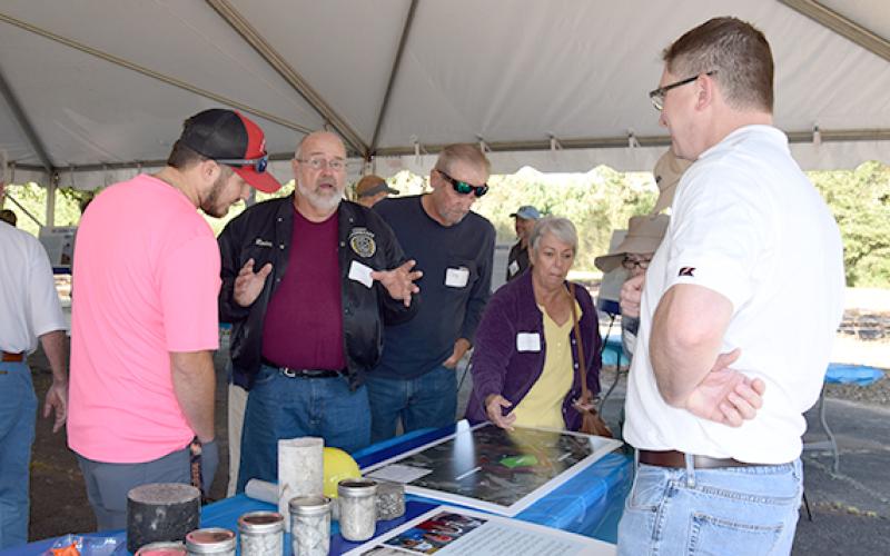Rodney Swinson (center), who lives in the Bradford Place subdivision adjacent to where Vulcan Materials plans to build a rock quarry, shares concerns during a neighborhood information session set up by the company Tuesday. (Photo by Sinclair)