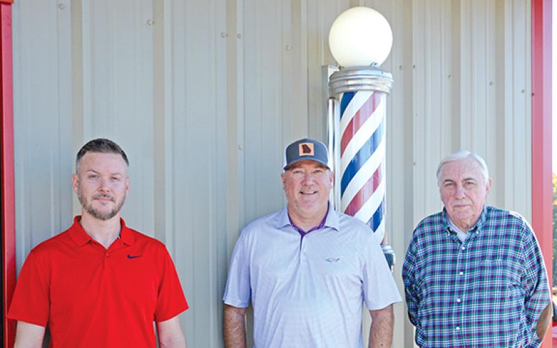 Mens World Barber Shop in Royston is celebrating 50 years in business. Founder Gayle Fields (above right) has retired but son Matt (above center) carries on the business with fellow barber Jame Lewis (above left).