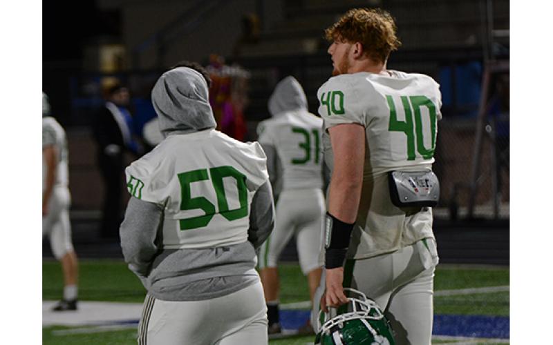 Senior Keylan Rutledge (No. 40) walks off the field for the final time in high school with injured junior center Tarryn Tate following Franklin’s loss to Oconee, now ranked No. 2 in the state. (Photo by Scoggins)