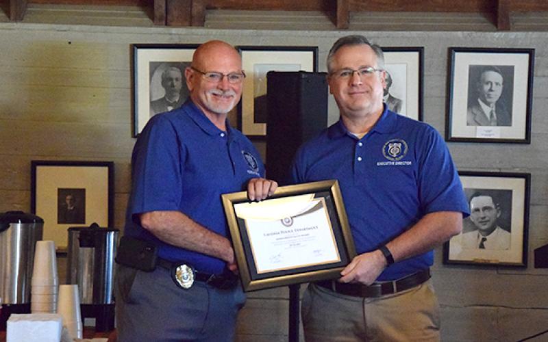 Lavonia Police Chief Bruce Carlisle receives the Meritorious Gold Award from Butch Ayers, the executive director of the Georgia Association of Chiefs of Police. (Photo by Sinclair)