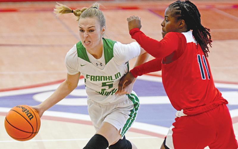 Bailey Aderholdt drives by a Winder-Barrow defender Monday in Jefferson. (Photo by Scoggins)