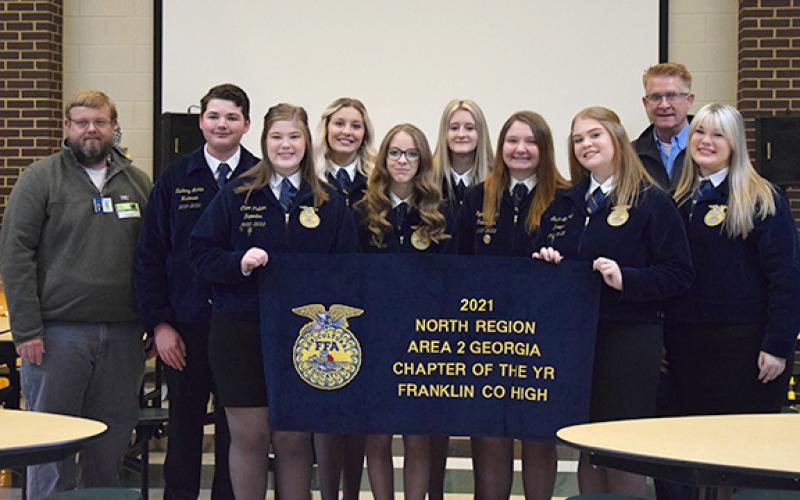 Kent Benson and Brian Elrick present Franklin County High School FFA officers Zach Martin, Chloe Pulliam, MaCaylee Childs, Ella Freeman, Josie Hallford, Sydney Allen, Gracie Minyard, and Carah Pulliam with the chapter’s 2021 Area 2 award. (Photo by Sinclair)