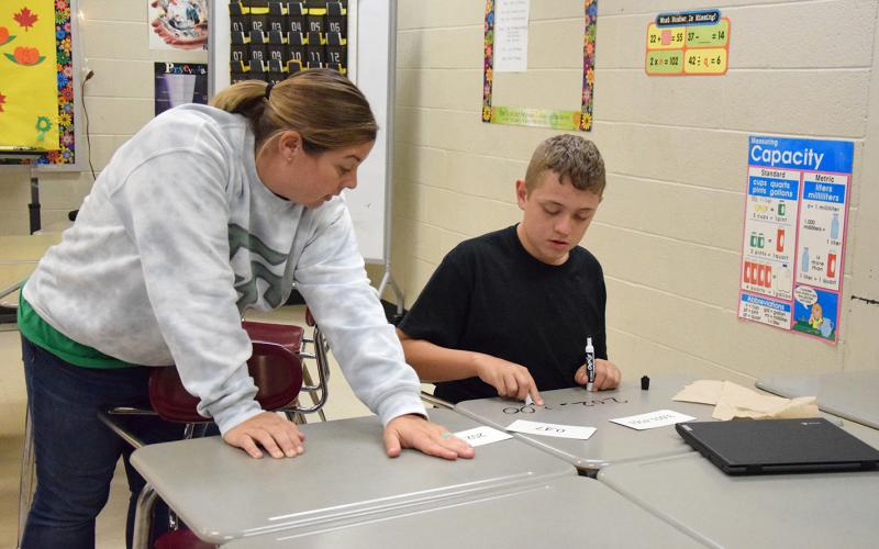 Franklin County Middle School teacher Amber Adams coaches Leland Rogers as he works on his rounding skills. (Photo by Sinclair)