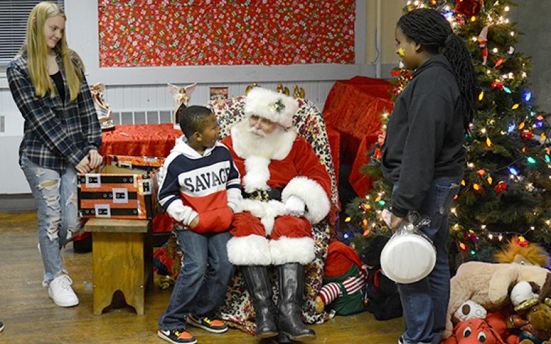 Step of Faith's annual Supper with Santa last week gave children an opportunity to discuss last-minute Christmas wishes with Santa. (Photo by Scoggins)