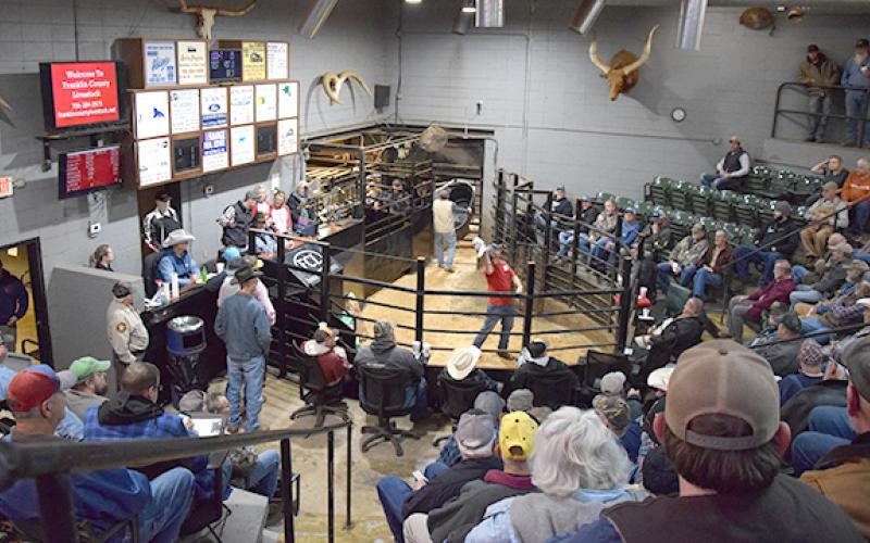 About 200 people filled the sales barn at Franklin County Livestock Tuesday to bid on items and raise money for Toys for Tots. (Photo by Sinclair)