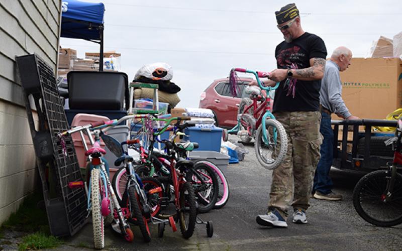 Lavonia VFW Post 5897 Commander Jason Nichols stacks bicycles that were donated to tornado victims in Mayfield, Ky., last week from Lavonia. The local post served as the statewide hub for VFW donations. (Photo by Sinclair)