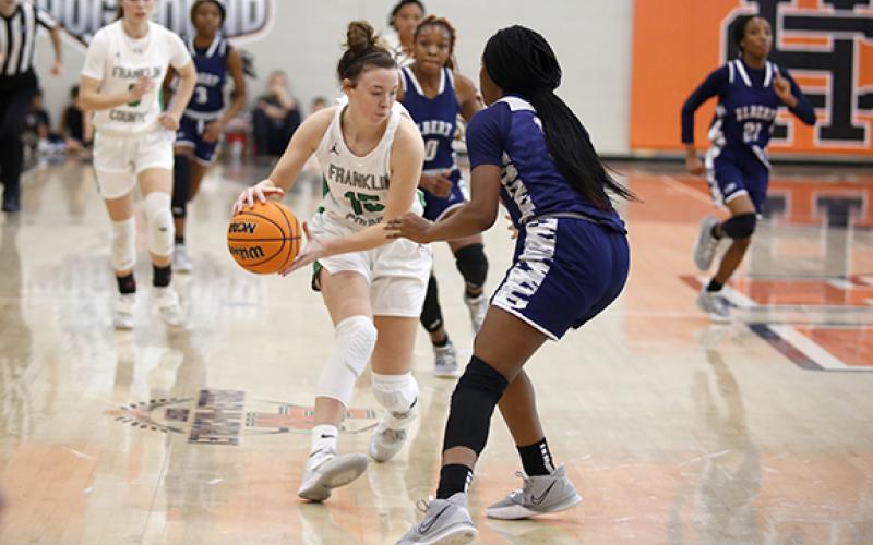 Lady Lion Emily Carson, who has provided defense and rebounding off the bench for Franklin County this season, is pressured by an Elbert County defender during a tournament in Hart County last week. (Photo by Rose Scoggins)