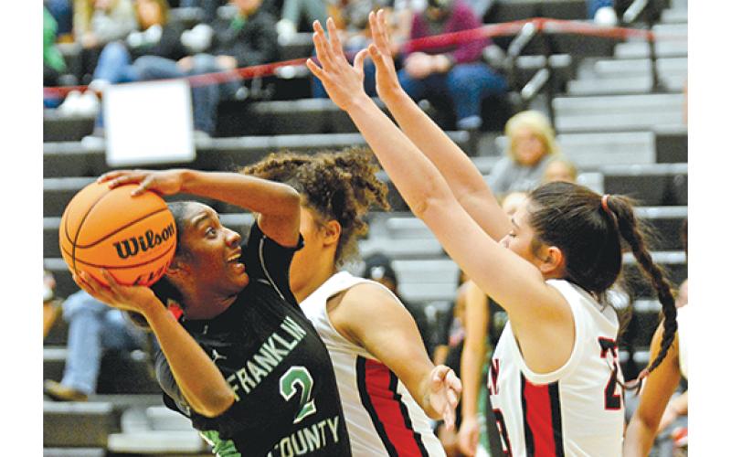 Franklin County’s Paris Gaye looks for a shot against two Stephens County defenders Friday night in Toccoa. Gaye and the Lady Lions blew out the Lady Indians 61-28 to start region play. (Photo by Scoggins)