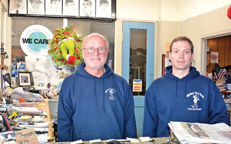John Sullivan (left), founder of Mayberry Tire &amp; Wheel, stands with new owner Sam Donaldson (right). Sullivan is preparing to retire from the cornerstone business in downtown Royston. (Photo by Scoggins)