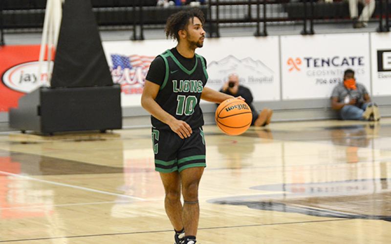 Keez Roebuck takes the ball down the court in a recent game. (Photo by Scoggins)