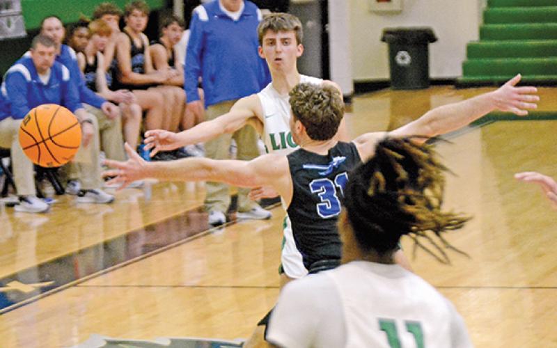 Cam Maxwell wraps a pass around an Oconee County defender to teammate David Witcher during action last week in the Lions’ Den. (Photo by Scoggins)