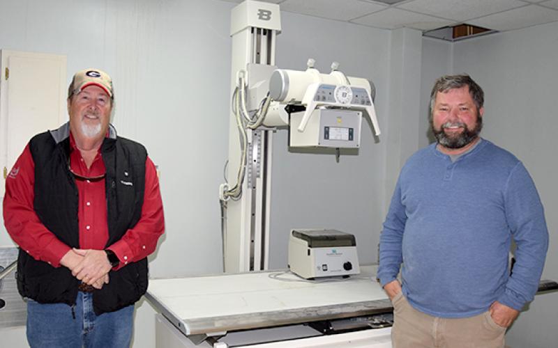 Jerry “Scoot” Rice and Scott Bailey are donating x-ray machine equipment left in the former medical building they turning into a storage facility. (Photo by Sinclair)