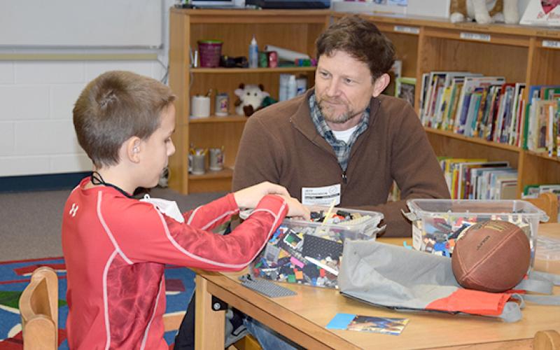 Mentor Jeff Stephenson talks with Shane as they build with Lego bricks together. The Franklin County Mentor Volunteer Program is in need of more volunteers like Stephenson. (Photo by Sinclair)