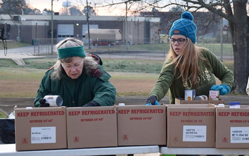 Volunteers organize food for distribution in the back parking lot of Lavonia Church of God during the mobile food pantry. (Photo by Sinclair)