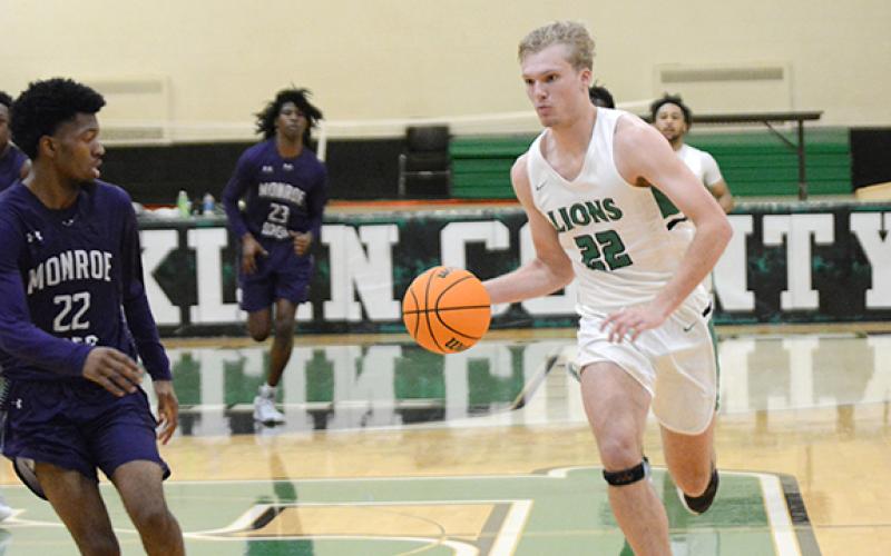 Dane Burton drives toward the basket in a win over Monroe Area Tuesday in Carnesville. (Photo by Scoggins)
