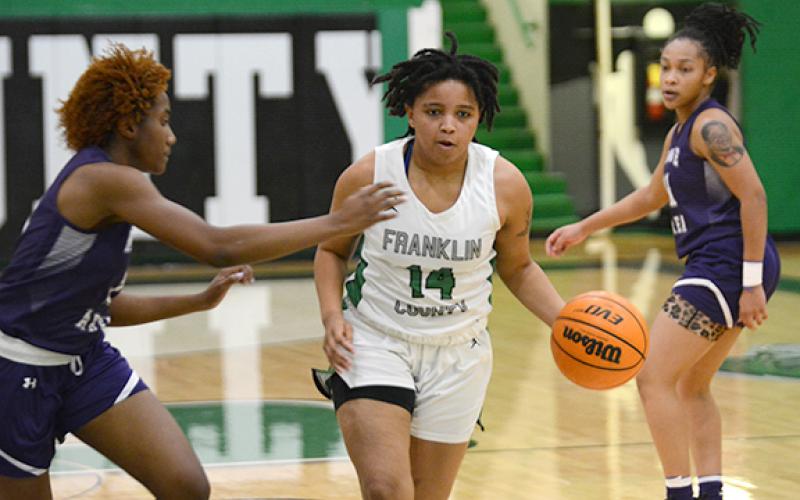 Ny’Kerriah Brown dribbles down court Tuesday in the Lady Lions’ dominant win over Monroe Area. (Photo by Scoggins)