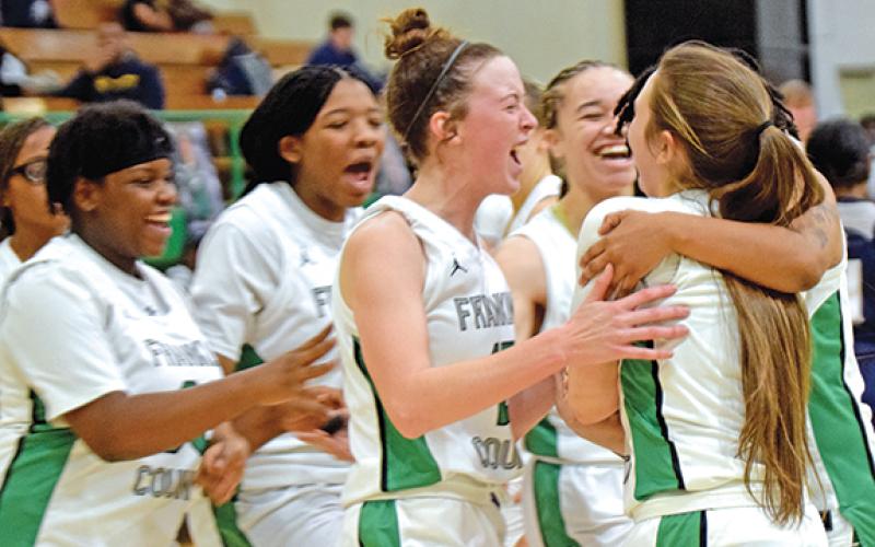 Teammates swarm Lady Lion Kayleigh Chappell after the senior made a buzzer-beating layup to tie the game in regulation Tuesday against East Jackson. The Lady Lions defeated the No. 6 Lady Eagles 55-47 in overtime. (Photo by Scoggins)
