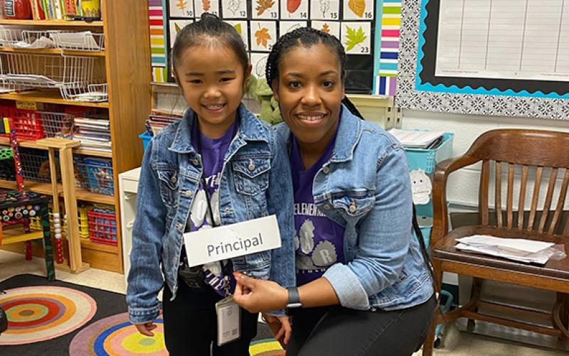 Royston Elementary School Principal Quowanna Mattox (right) poses with a student who dressed as her during a school dress-up day.