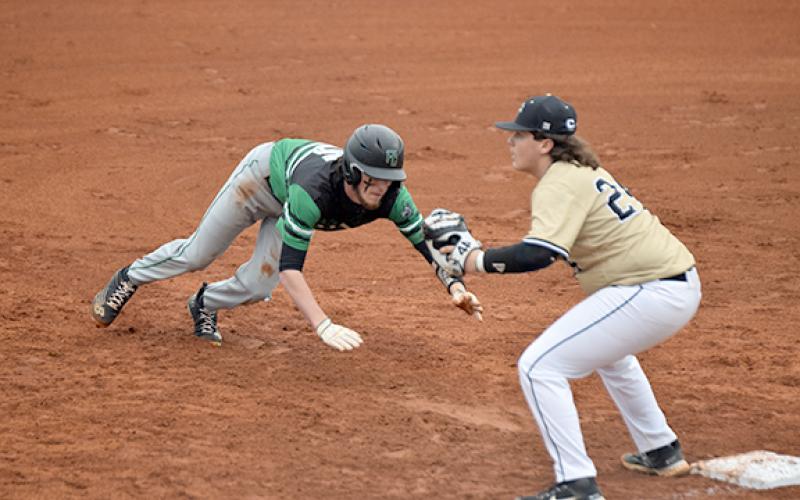 Landon Bruce dives back to first base to avoid being picked off during a game between the Franklin County Lions and Pendleton, S.C., Friday in Carnesville. (Photo by Scoggins)