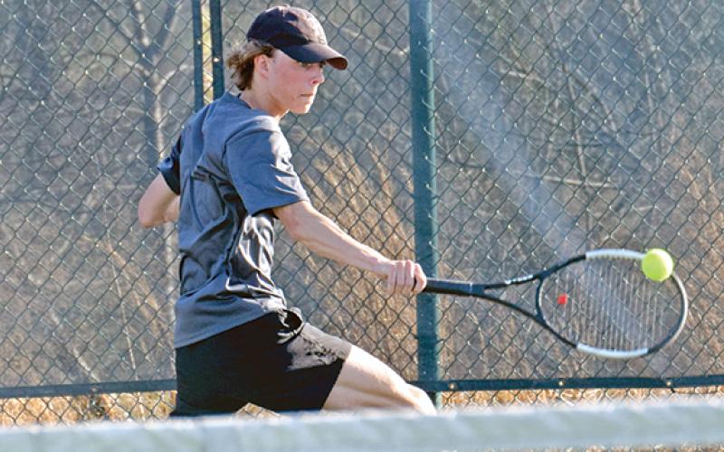 Franklin County singles tennis player Will Wester returns a ball during action last week at home against Oconee County.