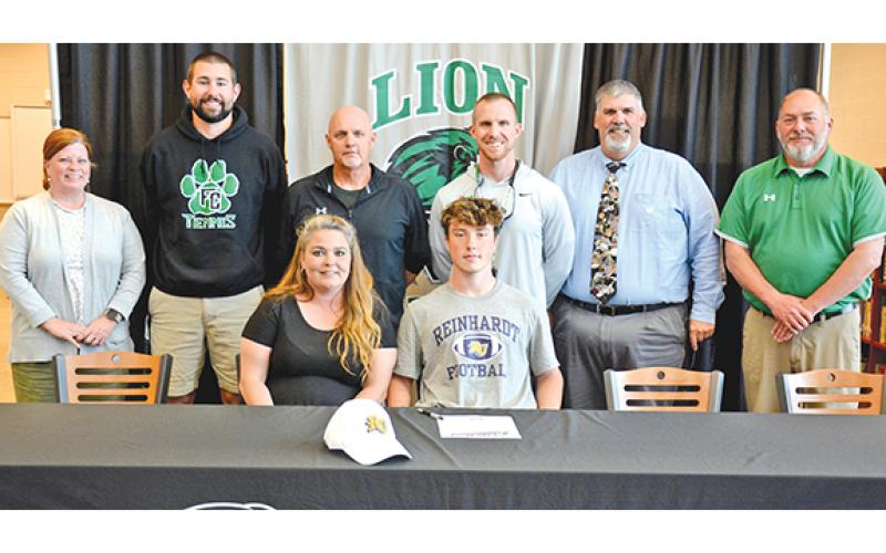 Participating in a signing ceremony for Chris Goode Monday at Franklin County High School were (front) mom Terrie, Chris, (back) FCHS Assistant Principal Natalie Erskine, Coach Bob Brunson, former FCHS Football Coach Paul Sutherland, FCHS Head Coach Parker Martin, Coach David Skelly and Athletic Director Jason Oliver. (Photo by Scoggins)