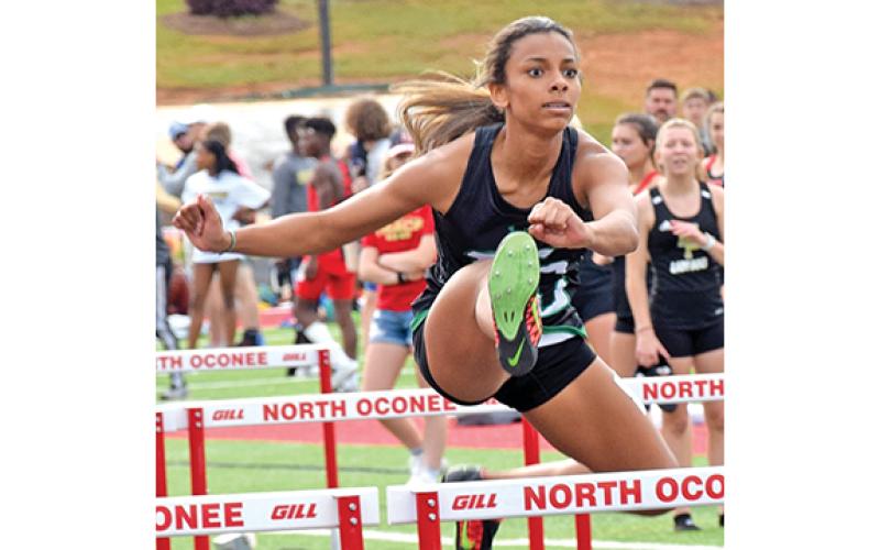 Alexus Knox, shown in a photo from a competition last season, broke the school record while winning first place at the prestigious Loch Johnson Invitational Saturday in Athens.