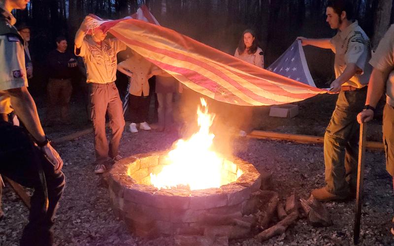 Lavonia Boy Scout Troop 51 members retire one of 15 worn American flags left in the flag retirement box during a flag retirement ceremony Monday at Lavonia Memorial Park. The ceremony was held following a fire pit dedication Monday night. Replacing the fire pit at the park was J.T. Strickland’s Eagle Scout project.