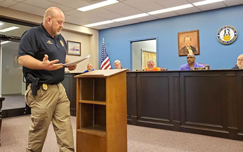 Royston Police Chief Donnie Bolemon explains how two businesses were caught selling alcohol to an underage officer at a called meeting of the Royston City Council Tuesday. After hearing from the businesses and changes they have made to make sure underage sales don’t happen again, the council reinstated the businesses’ alcohol licenses. (Photo by Sinclair)