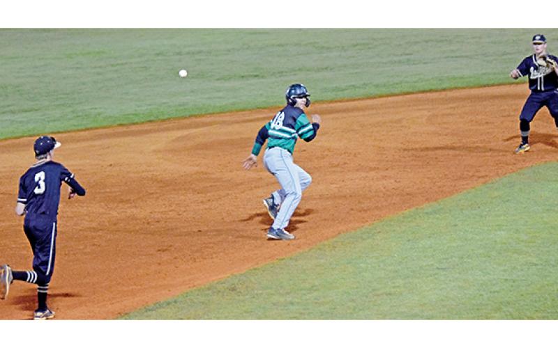 Lion A.J. Peeples scampers back toward second during a rundown play by T.L. Hanna last week in a non-region contest in Carnesville. (Photo by Scoggins)