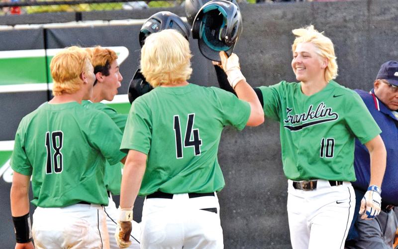 Celebrating a blond bomb: Lawson Gailey (left) crosses home plate after hitting a home run last week in the Franklin County High School baseball team’s first-round state playoff victory over Coahulla Creek. Teammates Ty Peeples, A.J. Peeples and Kayne Jinks await him to celebrate. The baseball team bleached their hair before the playoff games begin. (Photo by Scoggins)