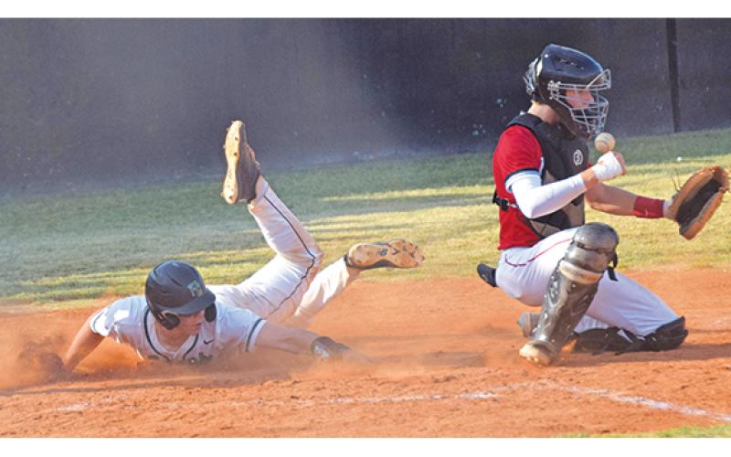 Lion A.J. Peeples slides in safely with one of Franklin County’s 10 runs in a 10-0 win over Morgan County in the second round of the state playoffs last week. (Photo by Scoggins)