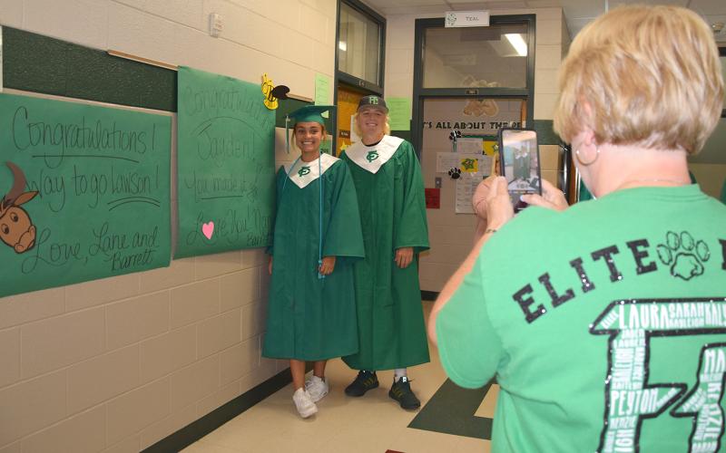 FCMS teacher Lane Gailey takes a photo of granddaughter Jayden and nephew Lawson during the Graduate Walk Thursday. Jayden and Lawson, both members of the Class of 2022, joined classmates in walking the halls of Franklin County’s elementary schools and the middle school. (Photo by Sinclair)