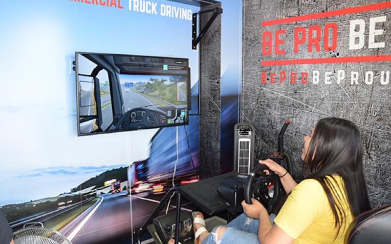 Keyry Moran tries out the truck driving simulator on the Be Pro Be Proud Mobile Workshop. (Photo by Sinclair)