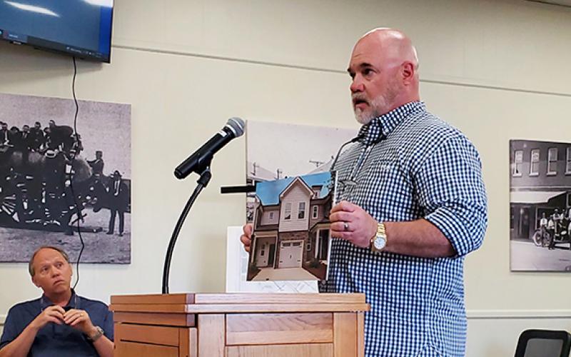 Scott Appling of GDP Investments shows an image of a unit recently built in Newnan, which is similar to what he plans to build in Lavonia. (Photo by Sinclair)