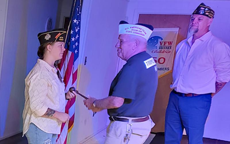 VFW Post 5897 Past Commander Jason Nichols (far right) watches as Commander Gabrielle Beutler is installed Thursday night.