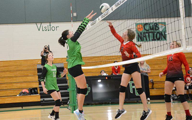 In the A-team game, Sydney Carson blocks a Rabun shot at the net. (Photo by Scoggins)