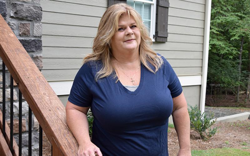 Beverly Folsom is working to reclaim Gumlog, where she lives, from a variety of problems that have beset the community. “It’s my little piece of paradise,” she said of her home. (Photo by Sinclair)