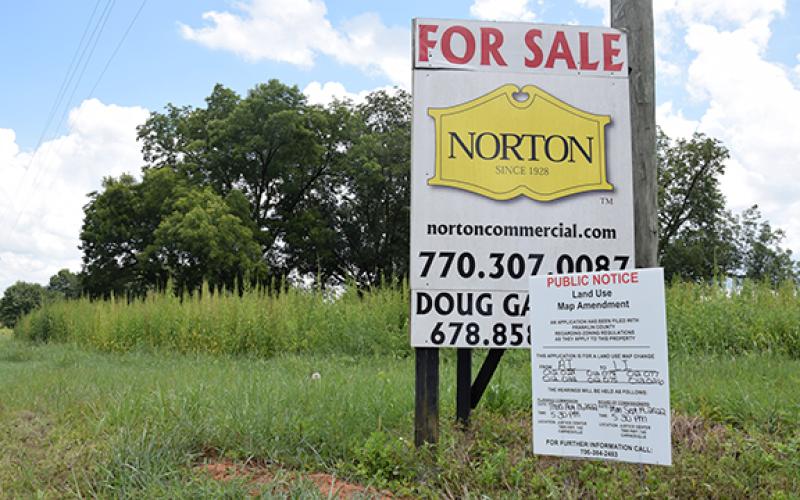 Signs posted on Old Federal Road notified the area of a rezoning request that was approved Monday for a new light industrial development.