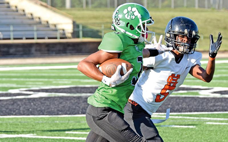Kain Winkfield stiff arms a Hart County defender during action Thursday in Carnesville.