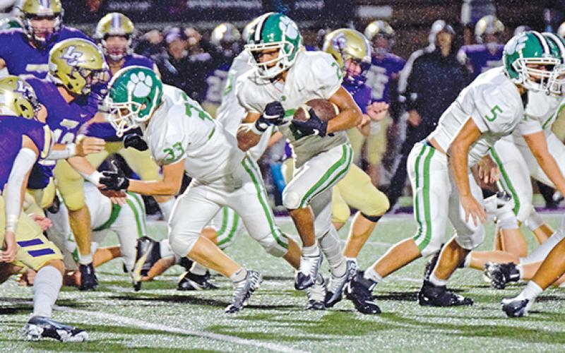 Freshman Nava Ware runs through a hole in the Lumpkin County line opened by Colbey Freeman (No. 33) and Tyler Pursley (No. 5) in action Friday in Dahlonega. (Photo by Scoggins)