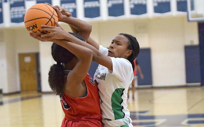 Ta’Kiaha Winkfield ties up a Flowery Branch ballhandler in tournament action Monday in Commerce. (Photo by Scoggins)