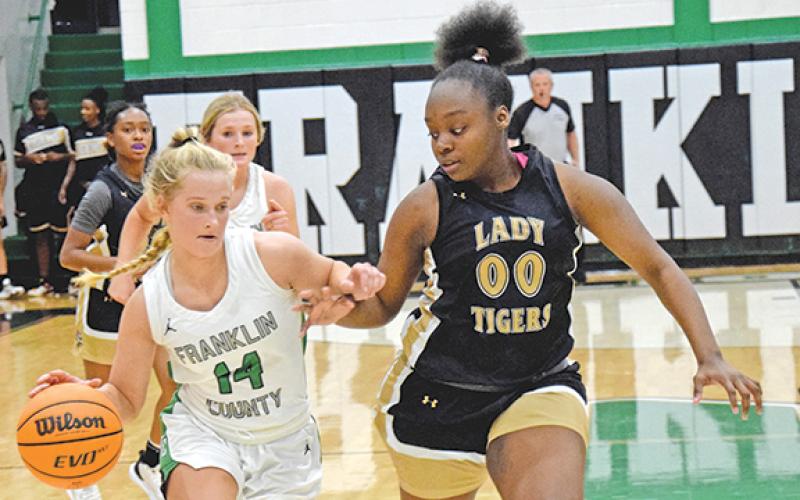 Jordis Haselton dribbles downcourt against Commerce Tuesday in the Lion’s Den. (Photo by Scoggins)