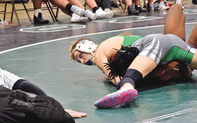 Lion Hunter Page looks to the referee for a pin in a victory over a Stephens County opponent Tuesday in the Coliseum in Carnesville. (Photo by Scoggins)