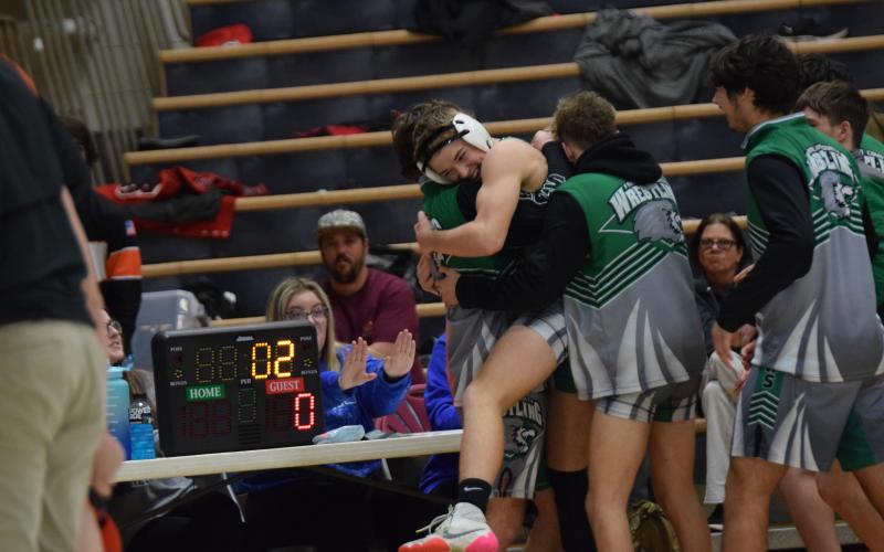 WATKINSVILLE – Will Ballenger is swarmed by his Franklin County Lion wrestling teammates Saturday after he pinned a Hart County opponent to clinch the FCHS program’s first-ever area duals championship. The Lions defeated Hart County and Stephens County two in the Area 8AAA title and will host two other teams in a state sectional Saturday at the Coliseum on Busha Road. The winner of the sectional will advance to the state duals championship tournament in Toccoa Jan. 21.