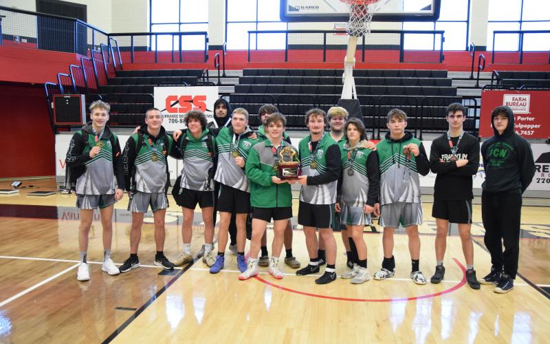 The Franklin County Lion wrestling team celebrate after receiving their Area 8AAA traditional team championship. (Photo by Scoggins)