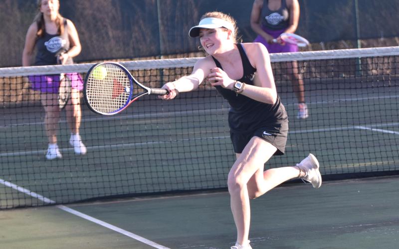 Senior Bonnie Greer Madden reaches for a volley Tuesday in action against Monroe Area in Carnesville. (Photo by Scoggins)