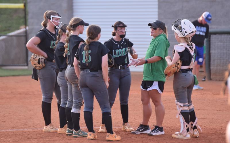 Head Coach Cherokee Bell (right photo) meets with her infield during Tuesday’s contest. (Photos by Scoggins)